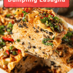 A close-up of a slice of dumpling lasagna being lifted from a white baking dish, showing layers of noodles, vegetables, and sauce.