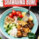A delicious chicken shawarma bowl featuring tender chicken shawarma, crisp cucumber, juicy tomatoes, red onion, fluffy couscous, creamy white sauce, and a fresh lemon wedge. A fork is picking up a savory piece of chicken. Text on the image says “Chicken Shawarma Bowl.”.