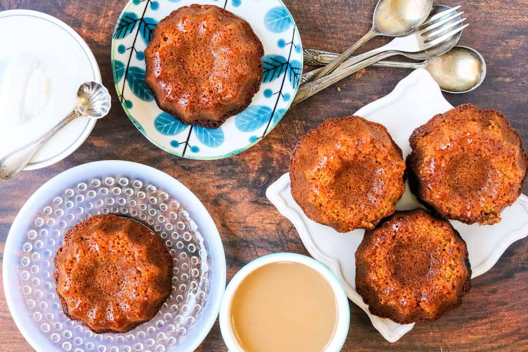 overhead shot of mini honey cake on plates with coffee and forks and spoons